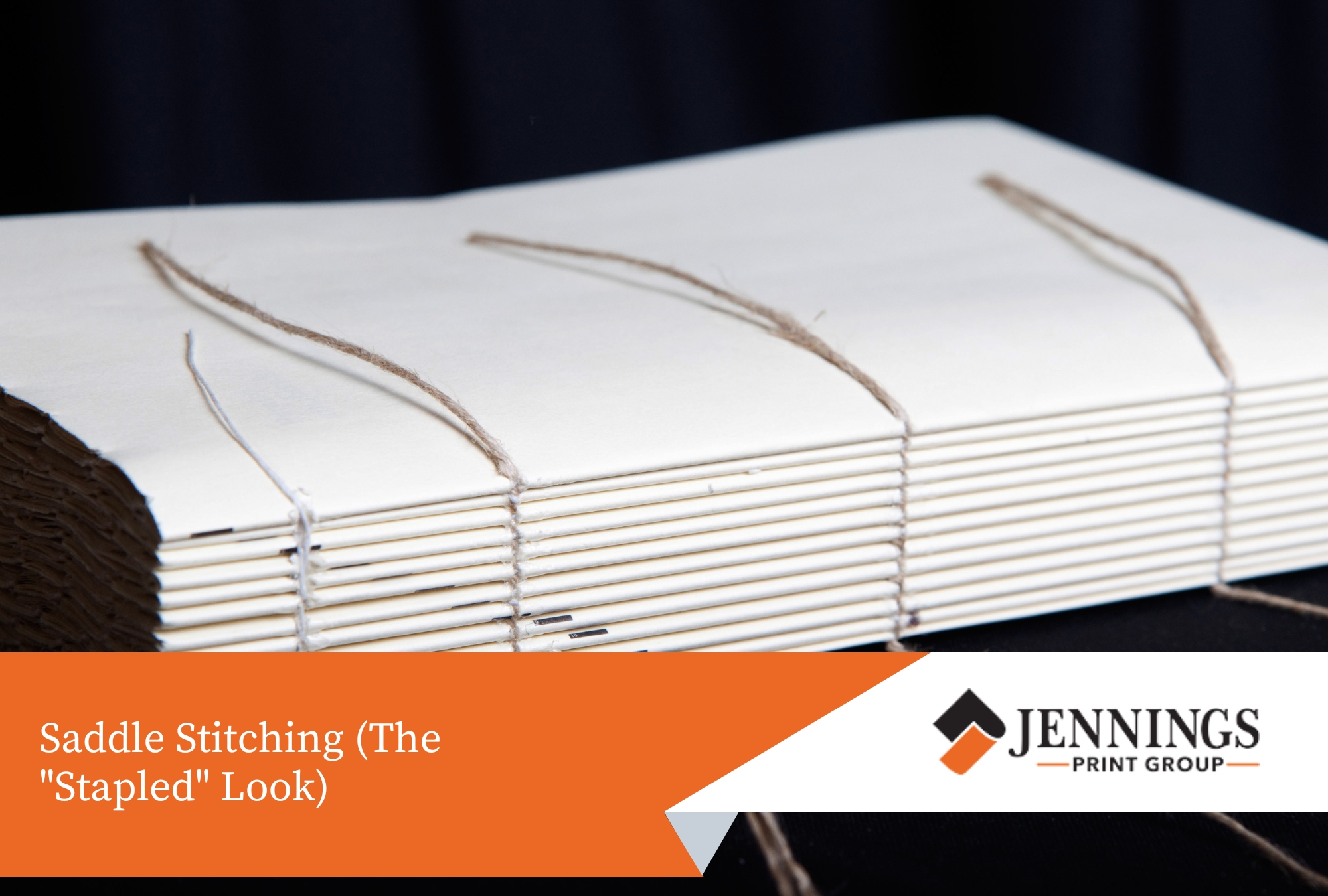 Open newsletter showing wire staples in the centre fold