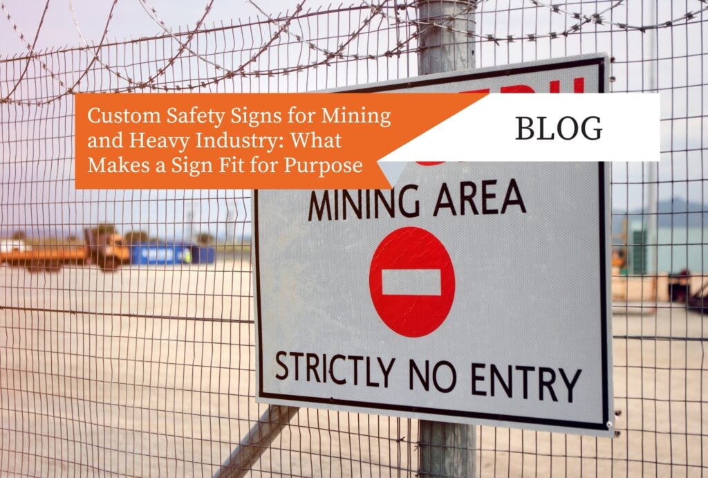 Custom industrial safety sign mounted on a security fence at a mining site.